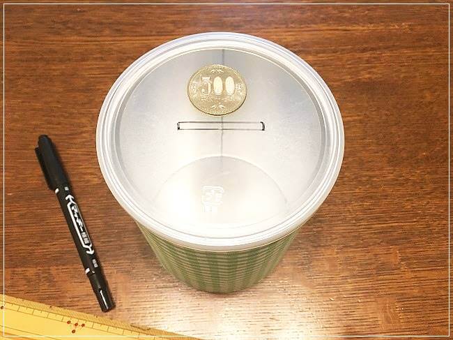 蓋にお金をいれる口をペンで書く