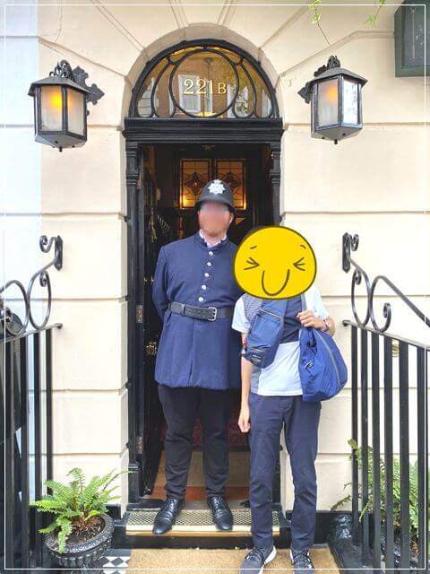 ロンドンのシャーロックホームズ博物館の入口にいるスコットランドヤード警察の服を着た係員